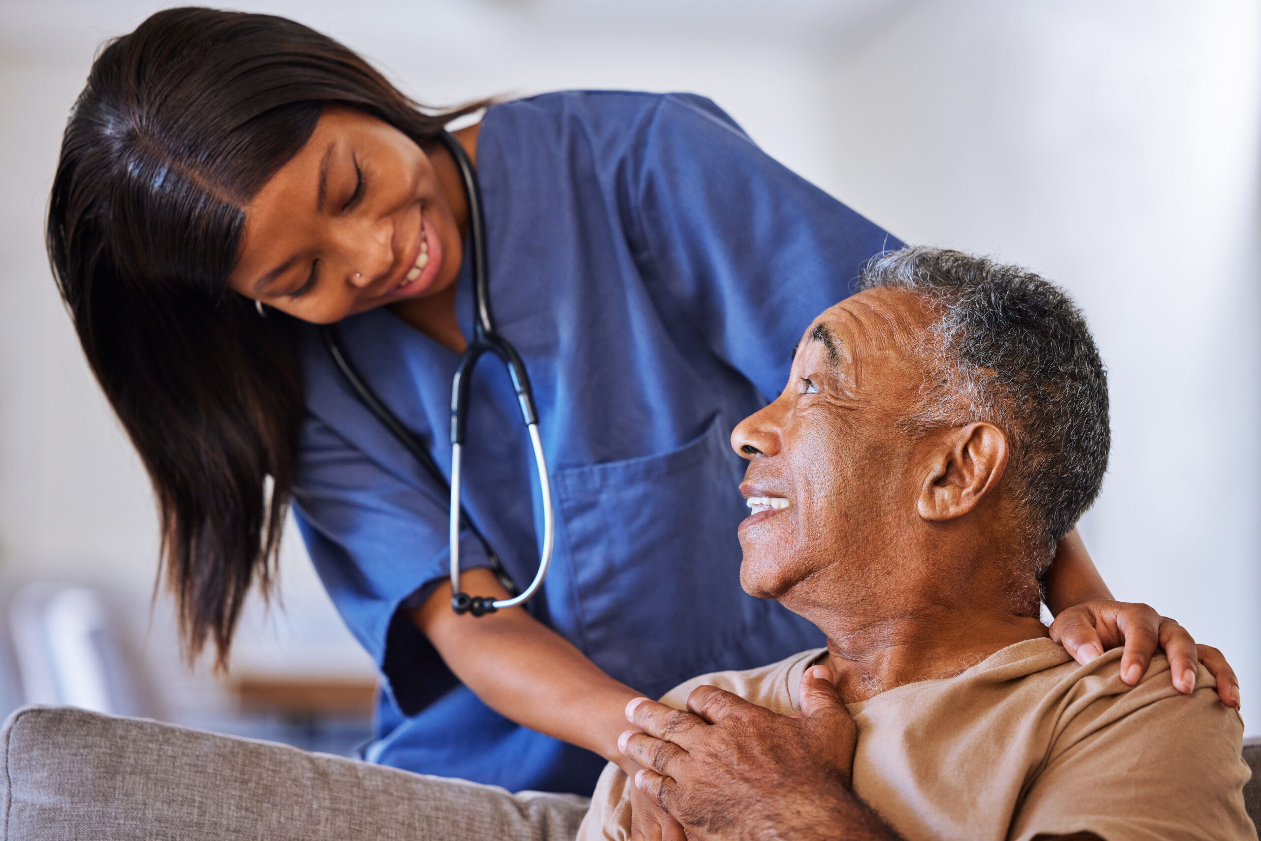 Nurse comforting an elderly patient